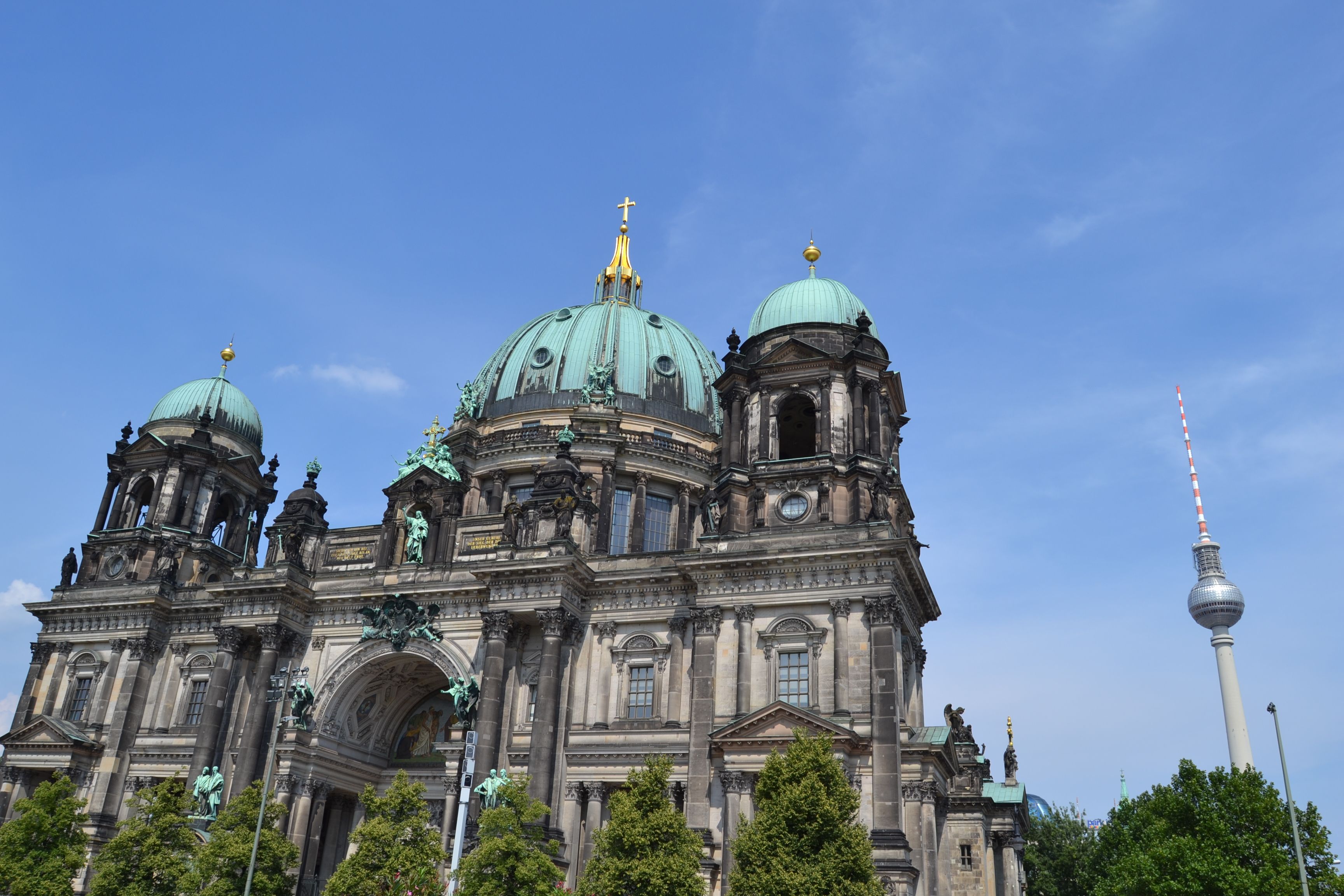 The Berlin Cathedral with the famous 'TV Tower' in the background against a bright blue sky