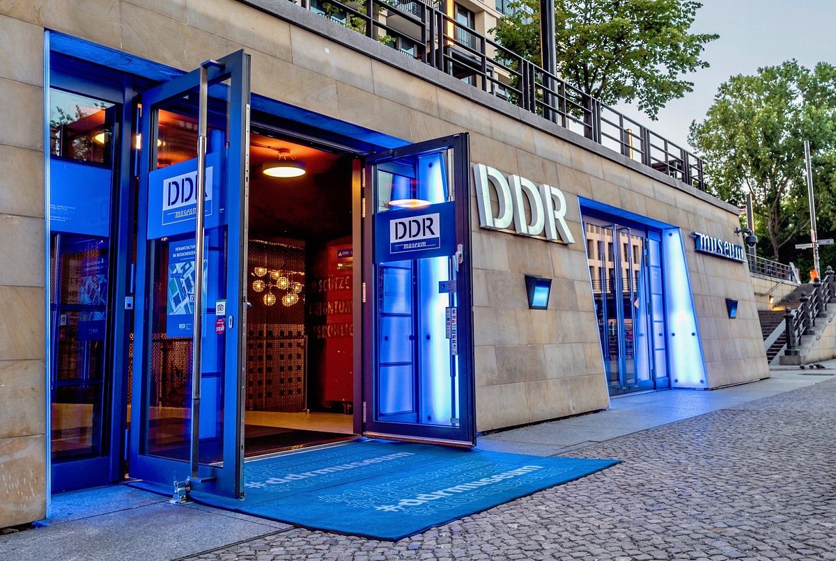 brick building with royal blue doors and carpet - the letters DDR are on the outside of the building